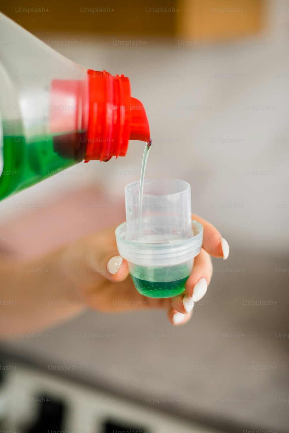 a person is holding a container with a liquid in it
