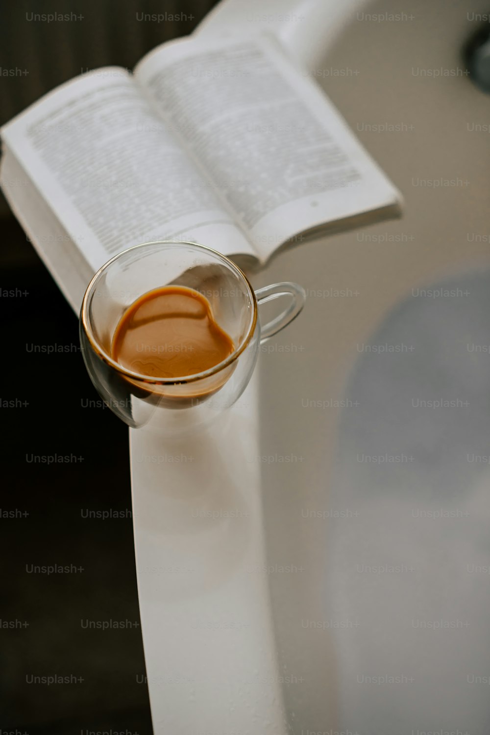a cup of coffee and an open book