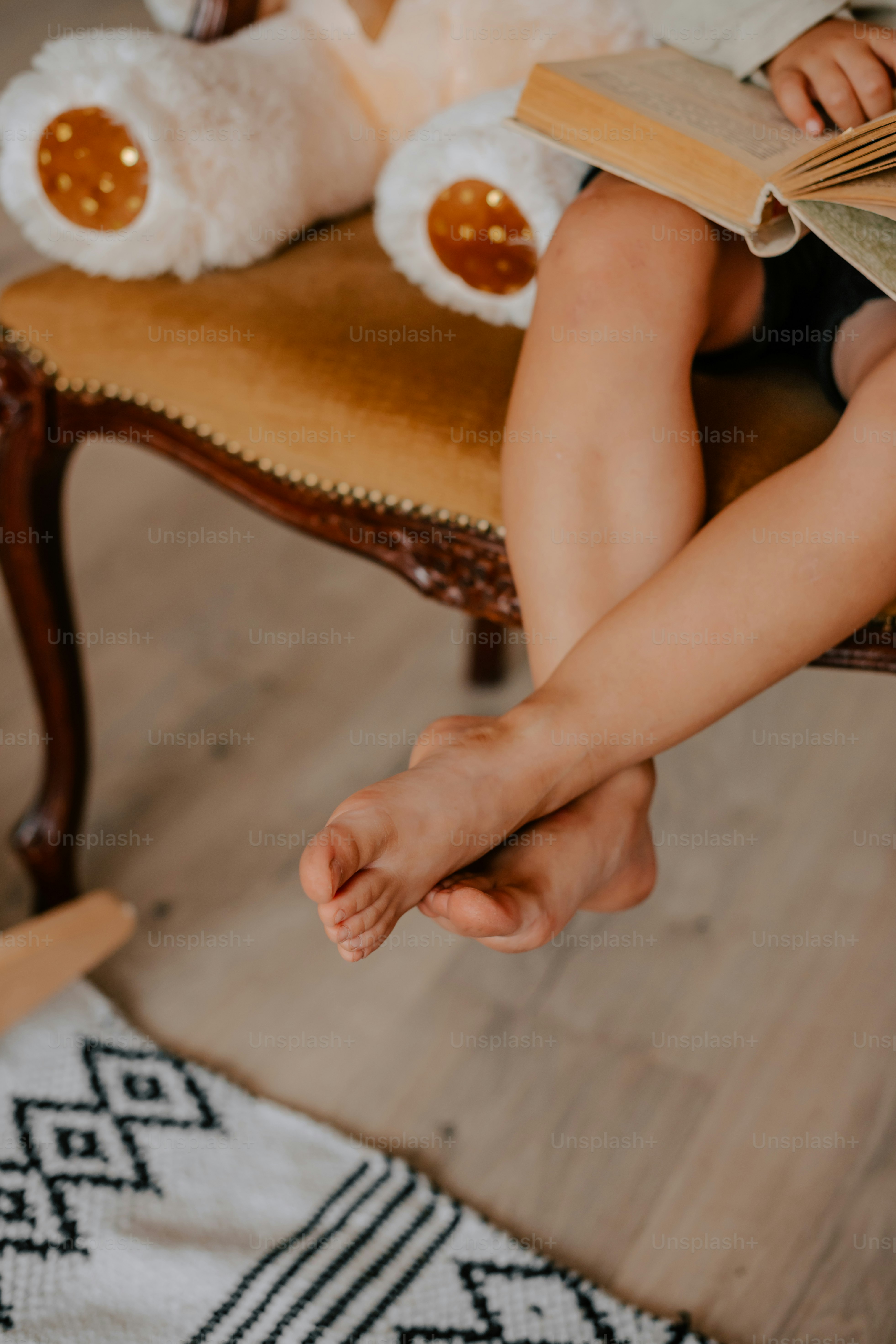 a person sitting on a chair reading a book