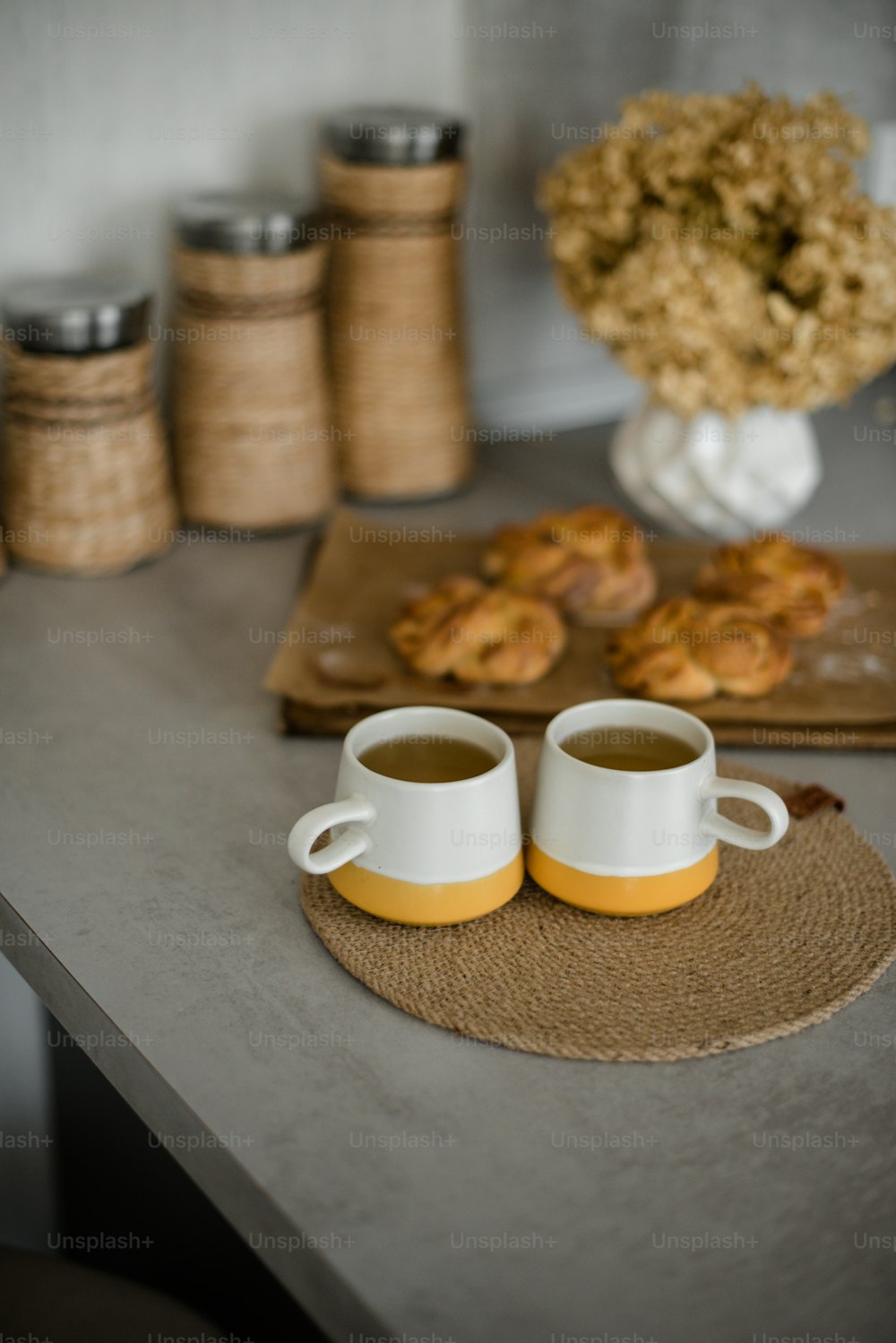 two mugs of coffee sitting on a table