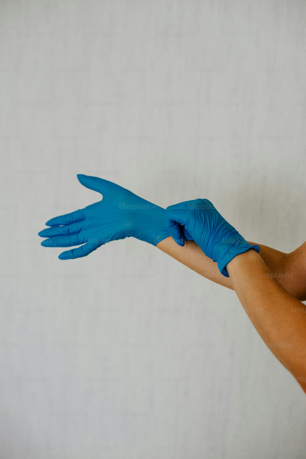 a person with blue gloves on their hands
