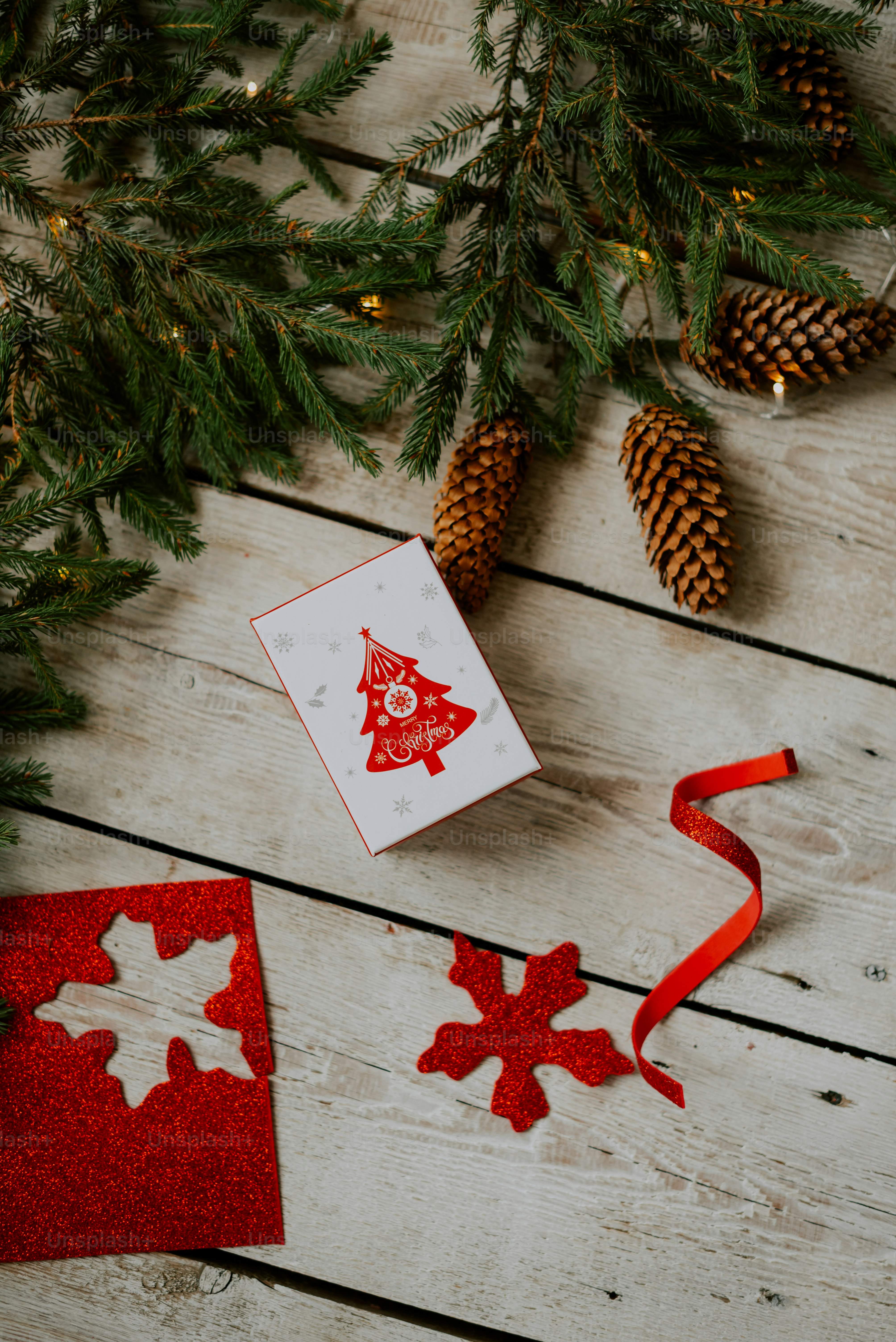 a christmas tree with a card and a red ribbon