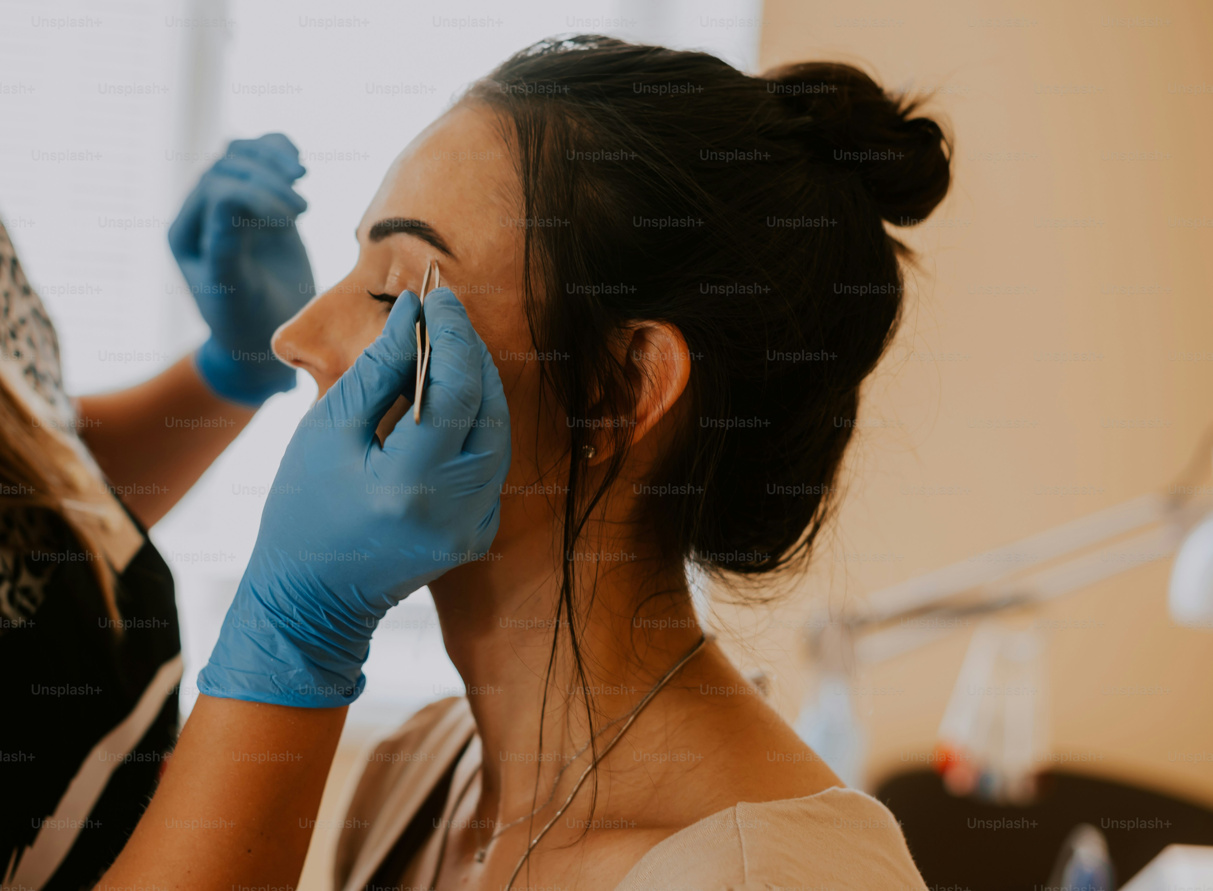 a woman getting her teeth brushed by a dentist
