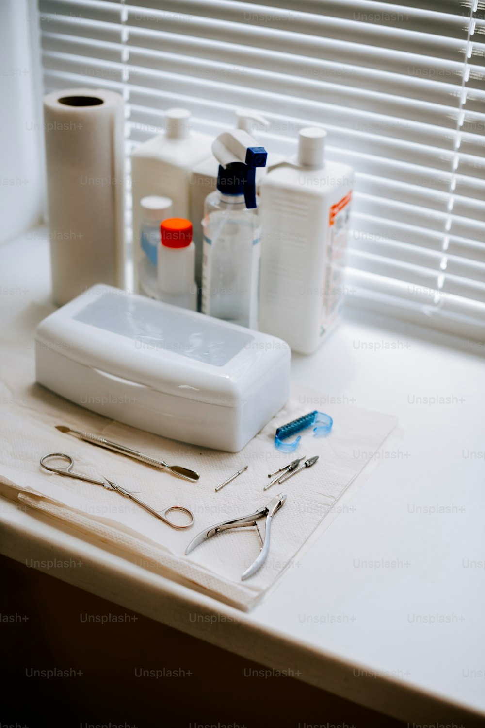 a pair of scissors, scissors, and other medical supplies on a counter