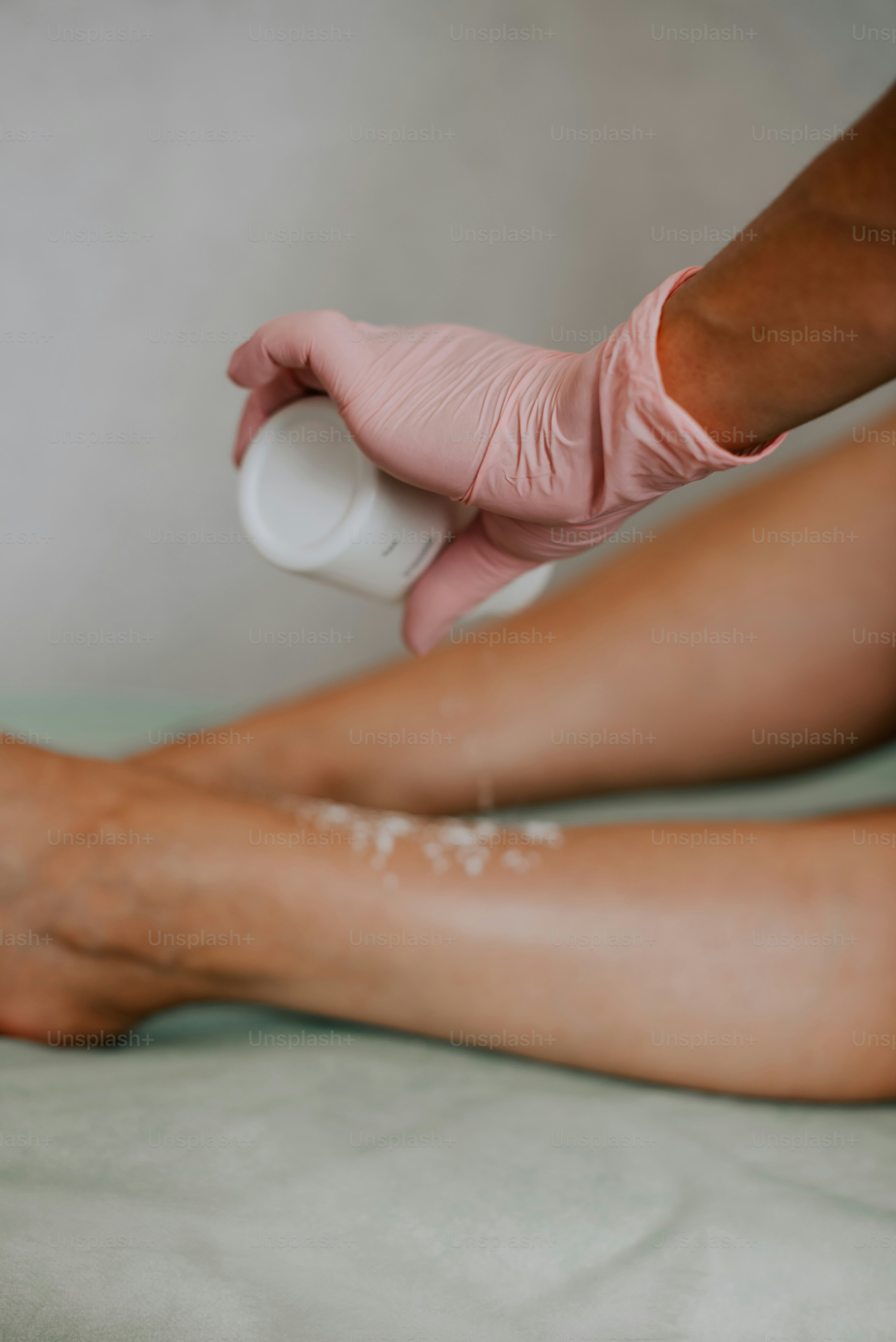 a person in pink gloves and latex on their feet