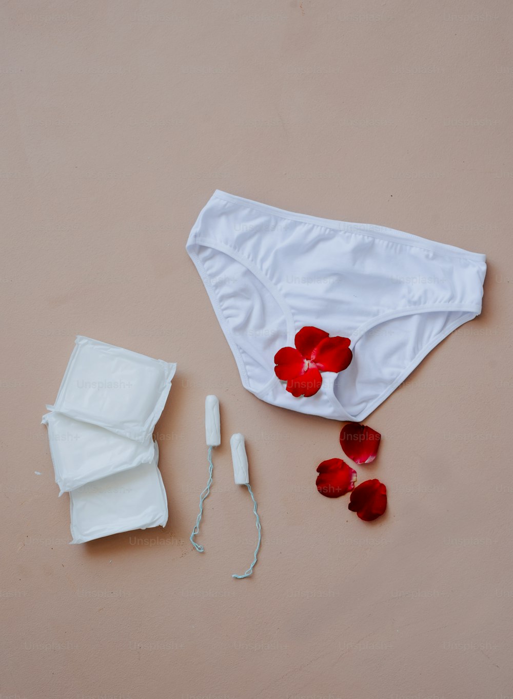 a pair of underwear and a flower on a table