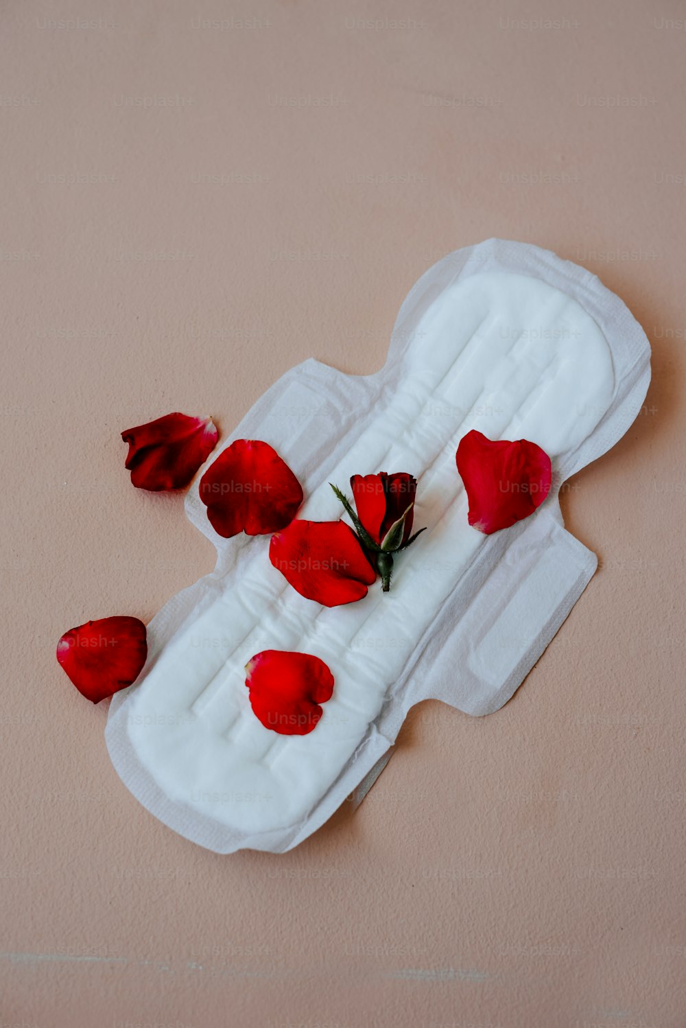 a pair of sanitary pads with red flowers on them