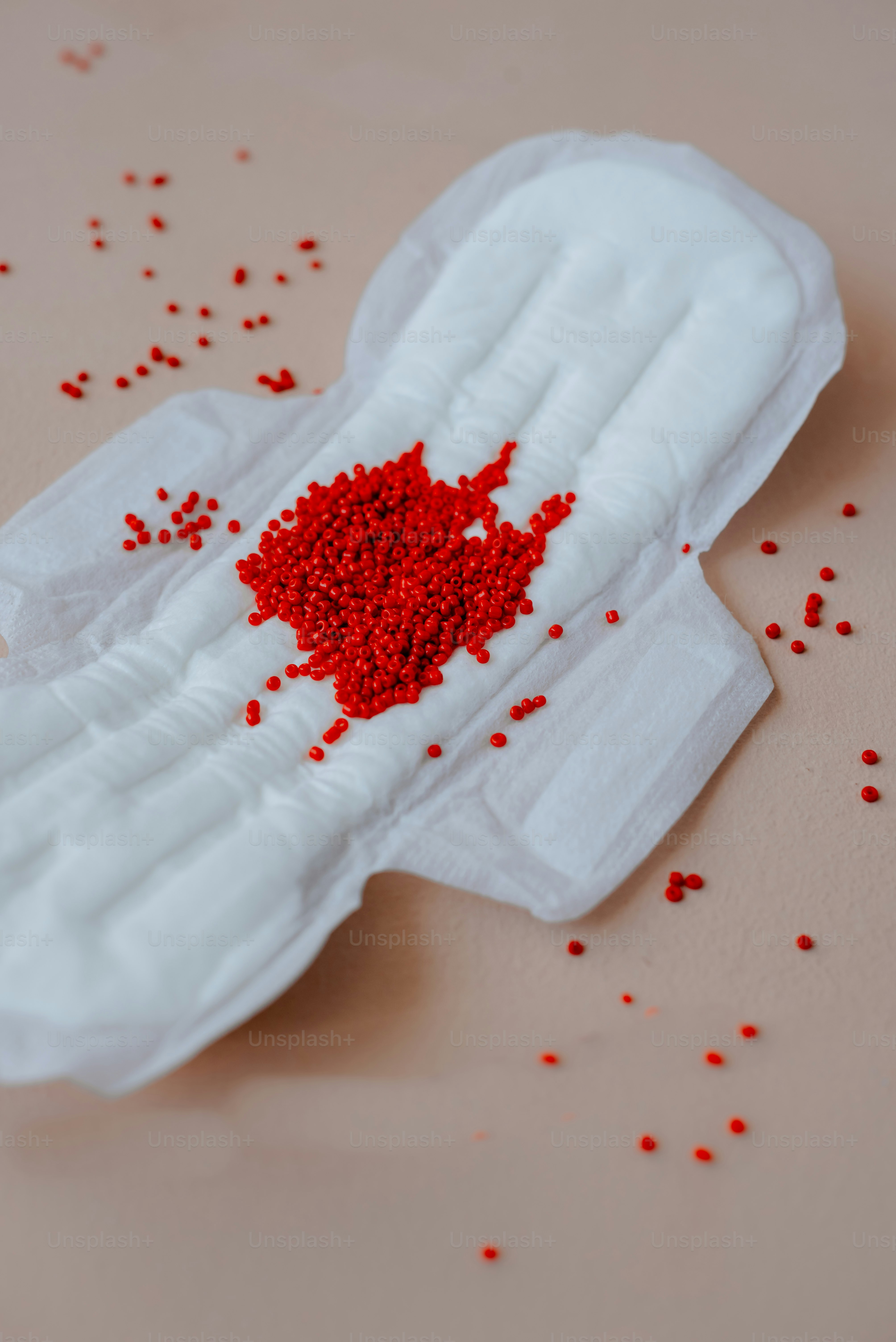 a pair of white gloves with red sprinkles on it