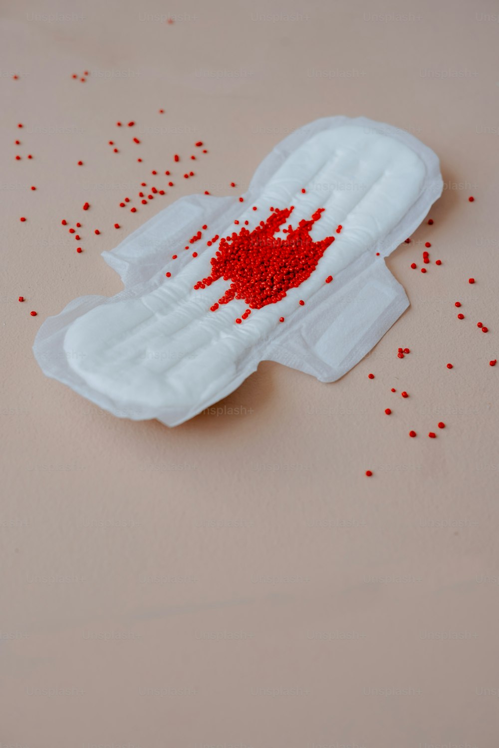a piece of white paper with red sprinkles on it