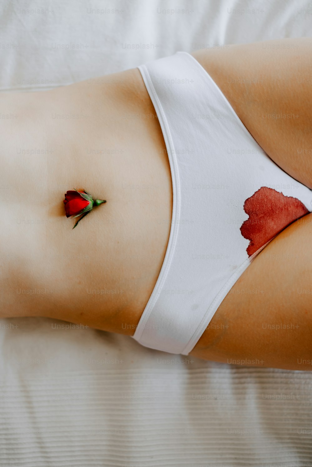 a woman with a rose tattoo on her stomach