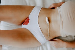 a woman in a white bra laying on a bed