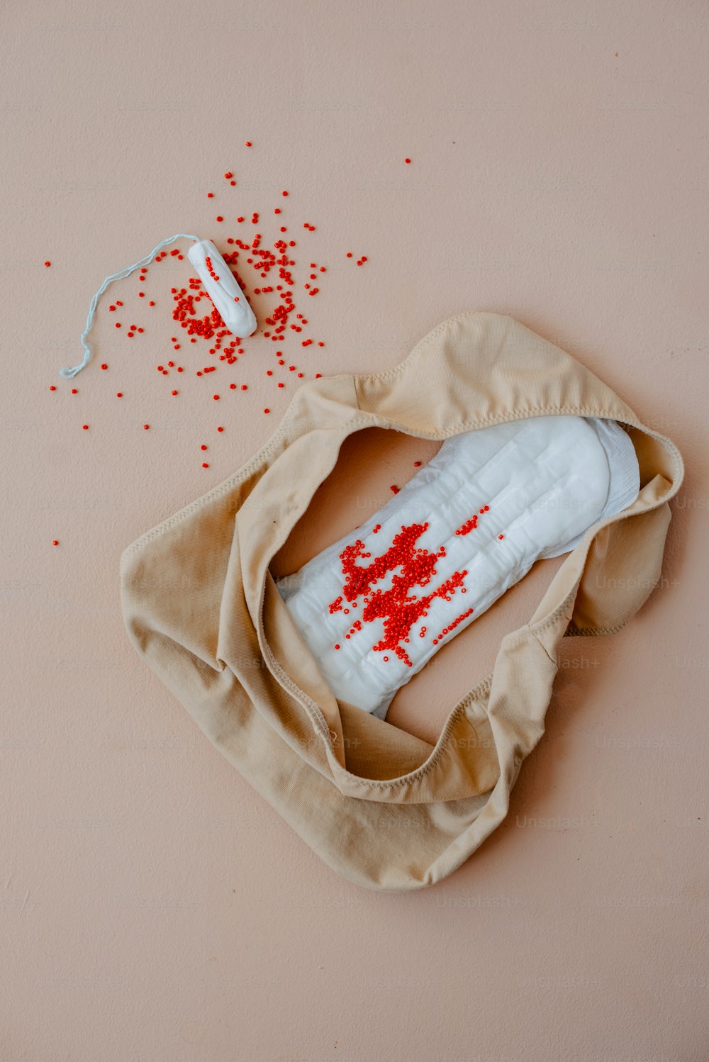 a piece of cloth with a piece of white and red sprinkles on