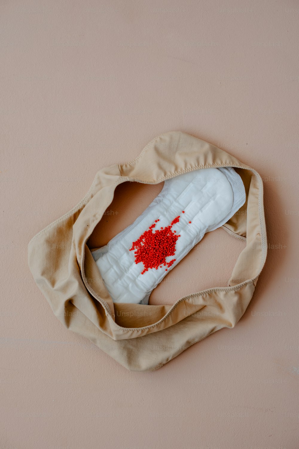 a pair of white shoes with red splatters on them
