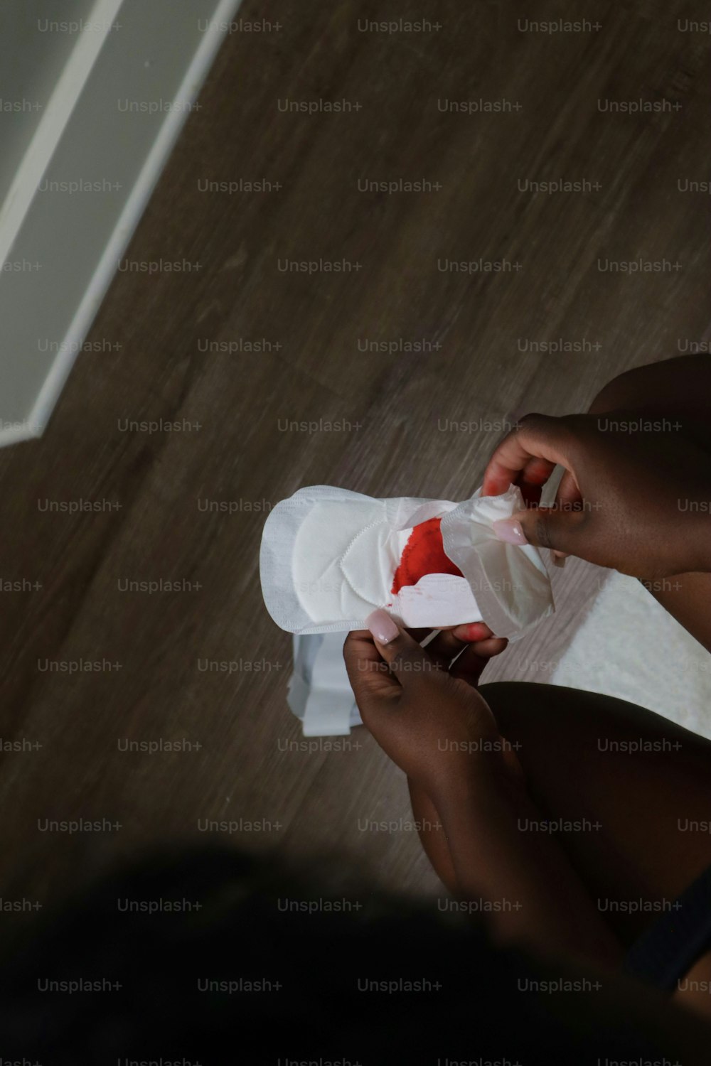 a woman sitting on the floor holding a piece of paper