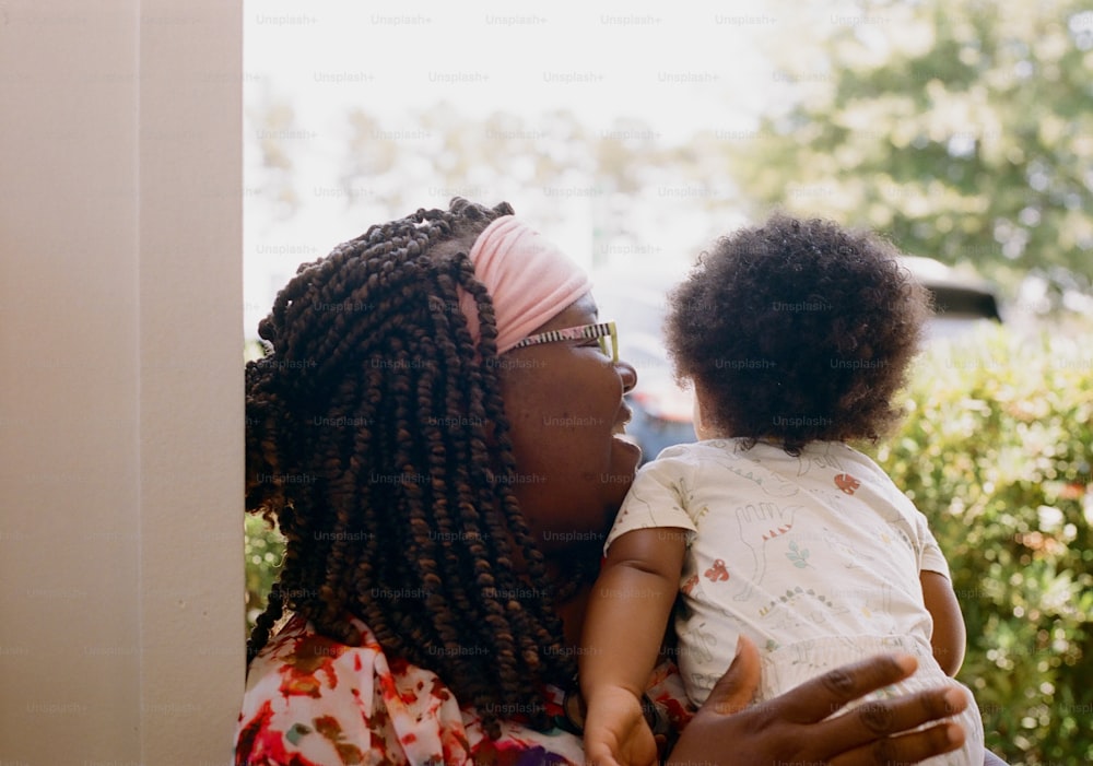 a woman holding a small child in her arms