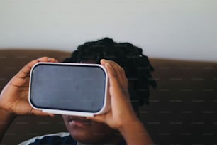 a person holding a cell phone up to their face