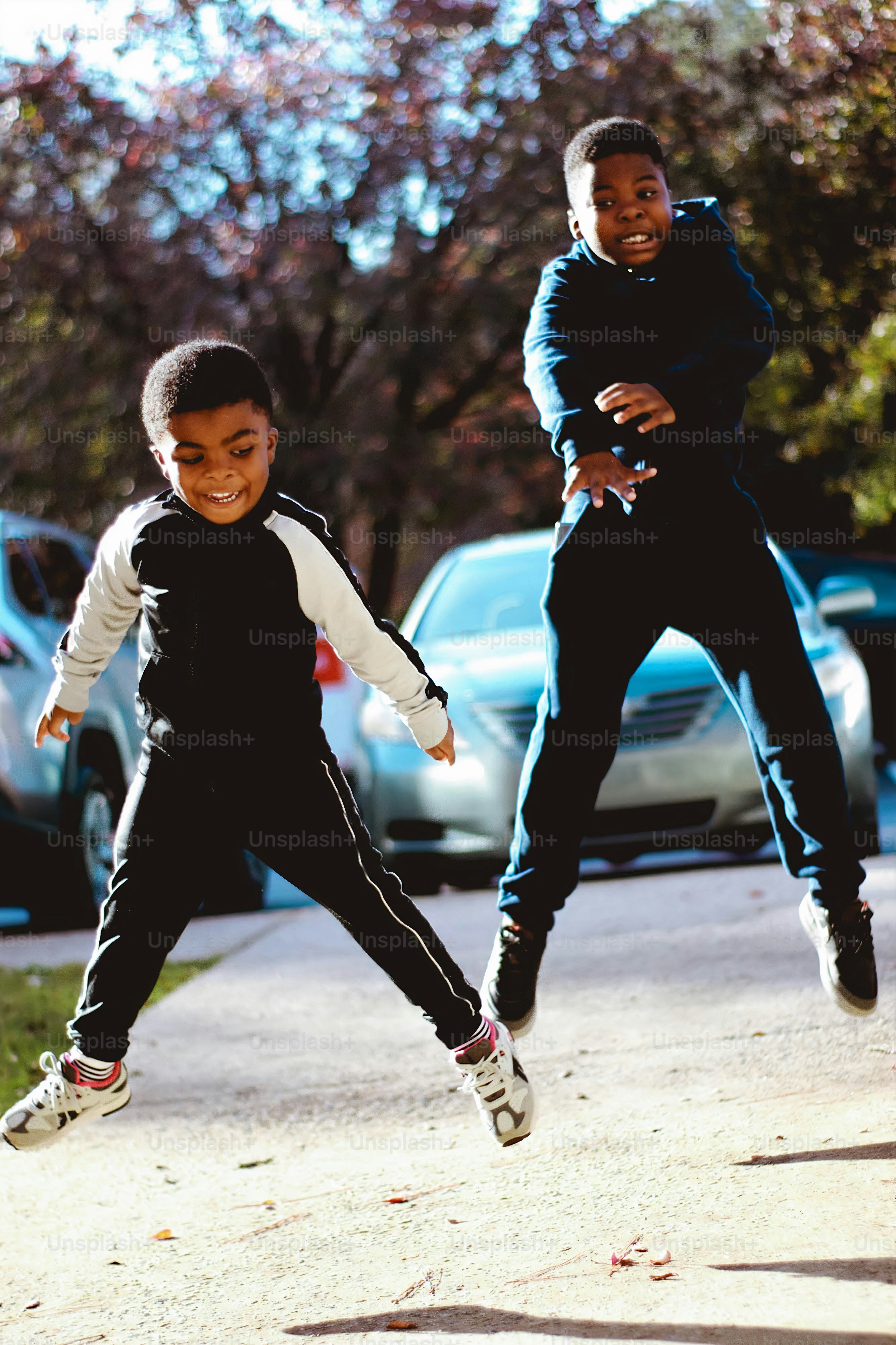 a couple of kids that are jumping in the air