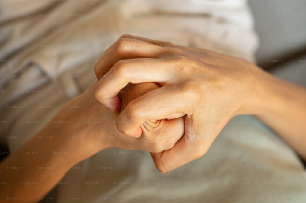 a close up of a person's hand on a bed