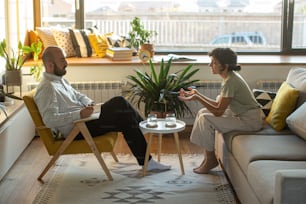 a man and a woman sitting on a couch talking