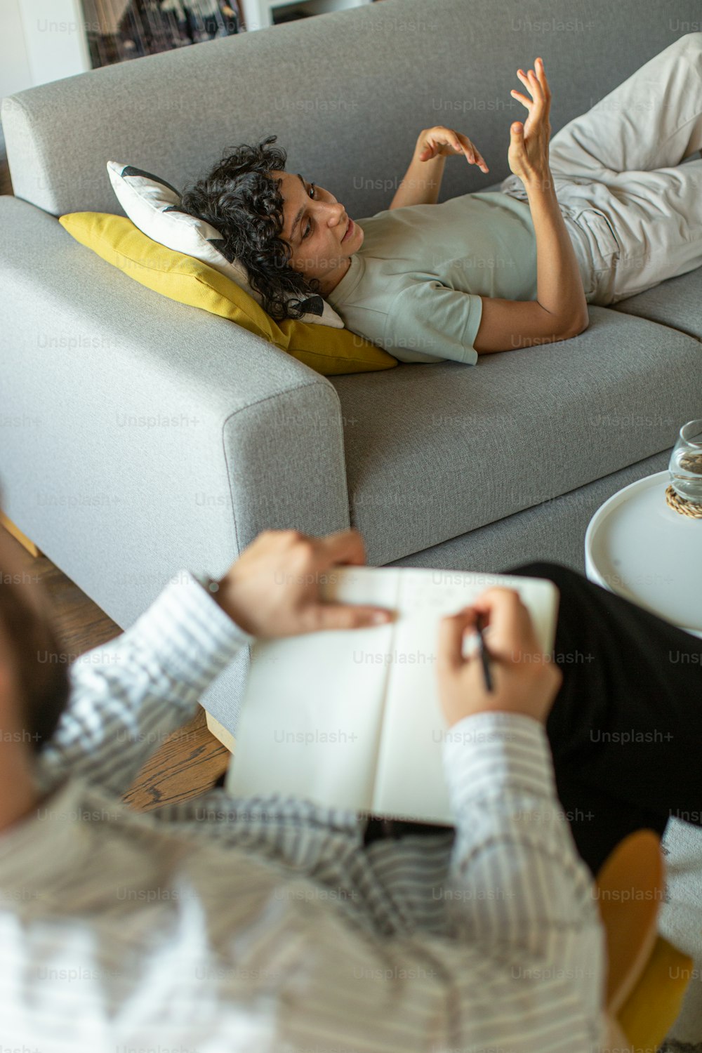 a man laying on top of a couch next to a woman