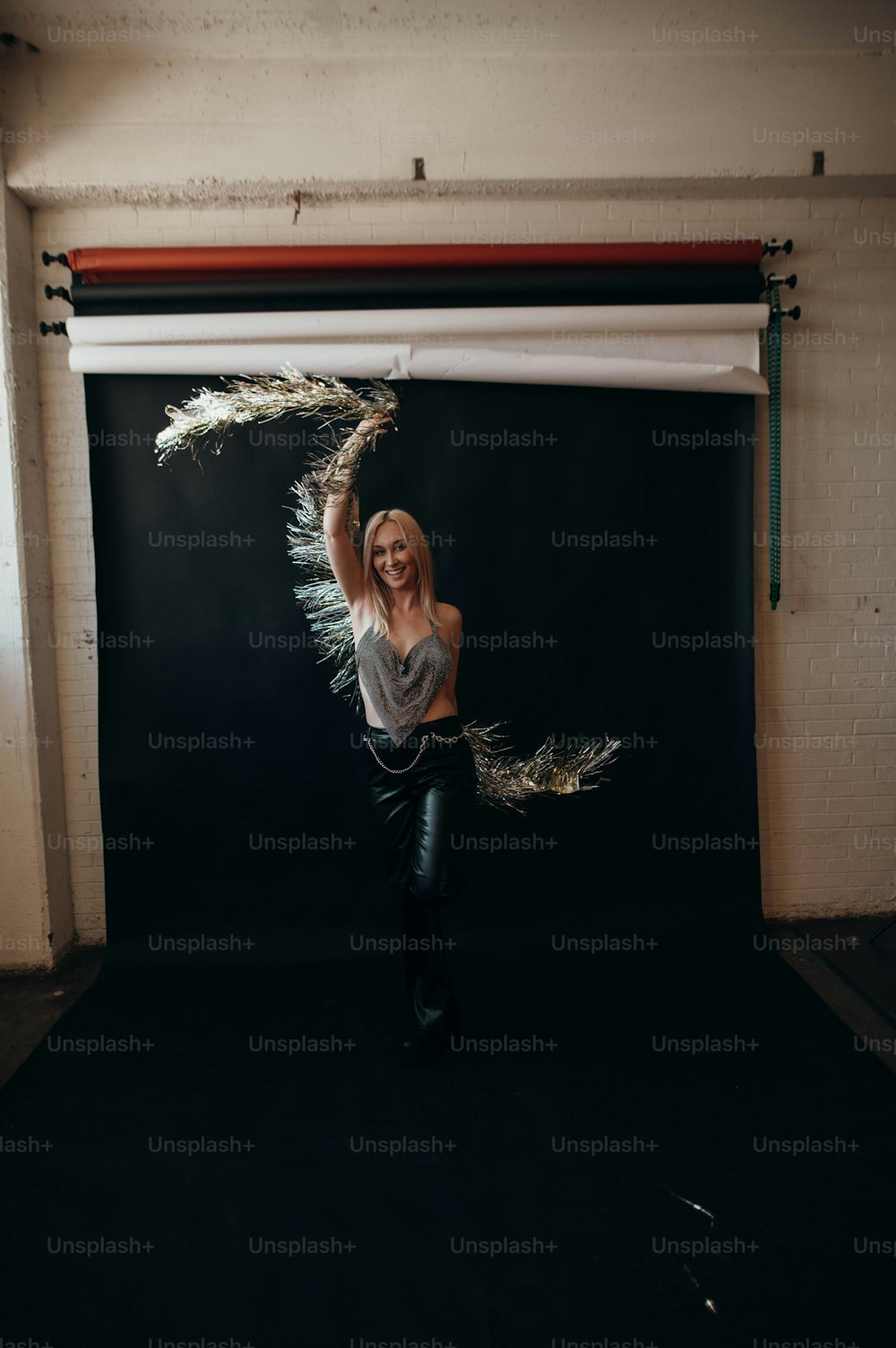 a woman standing in front of a black backdrop