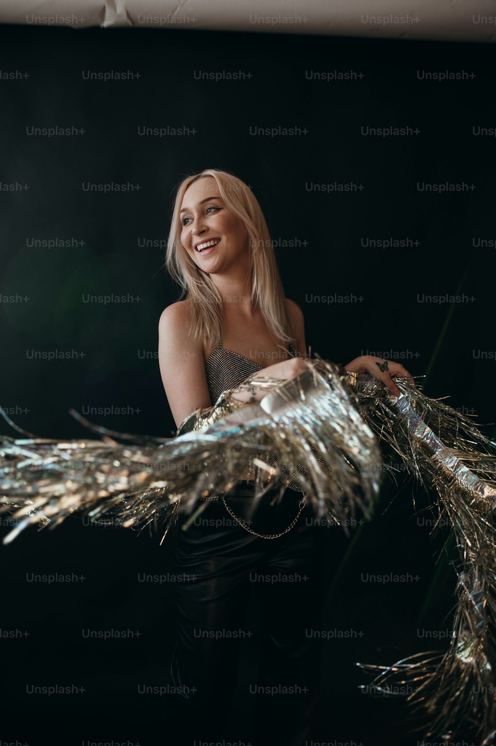 a woman is holding a bunch of tinsel