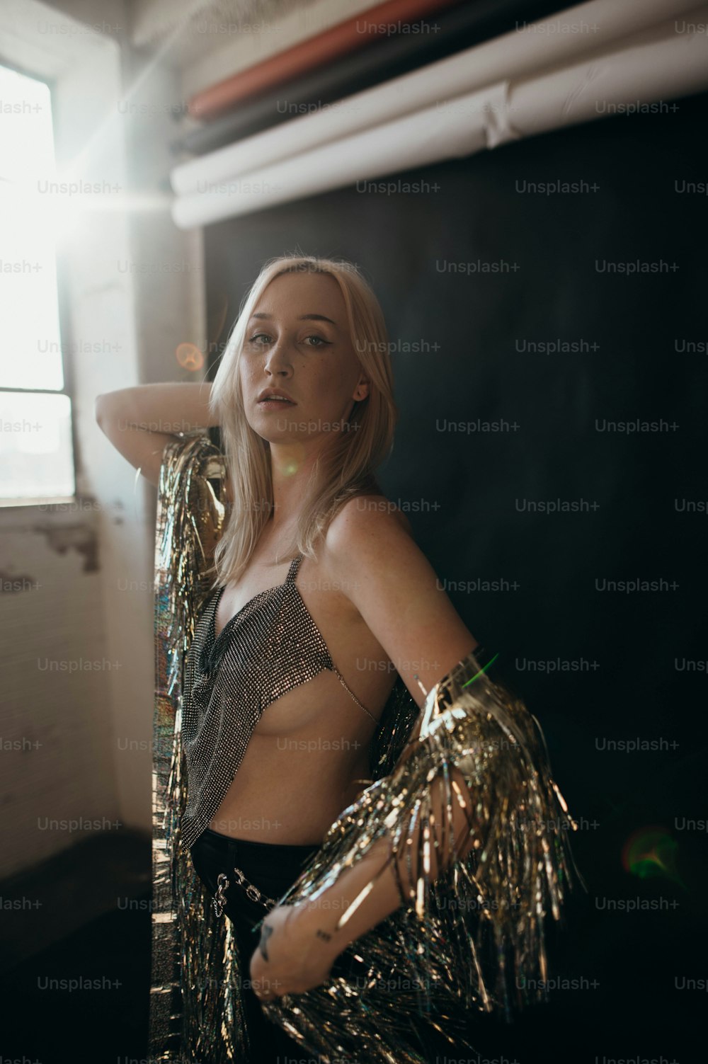 a woman in a metallic outfit posing for a picture
