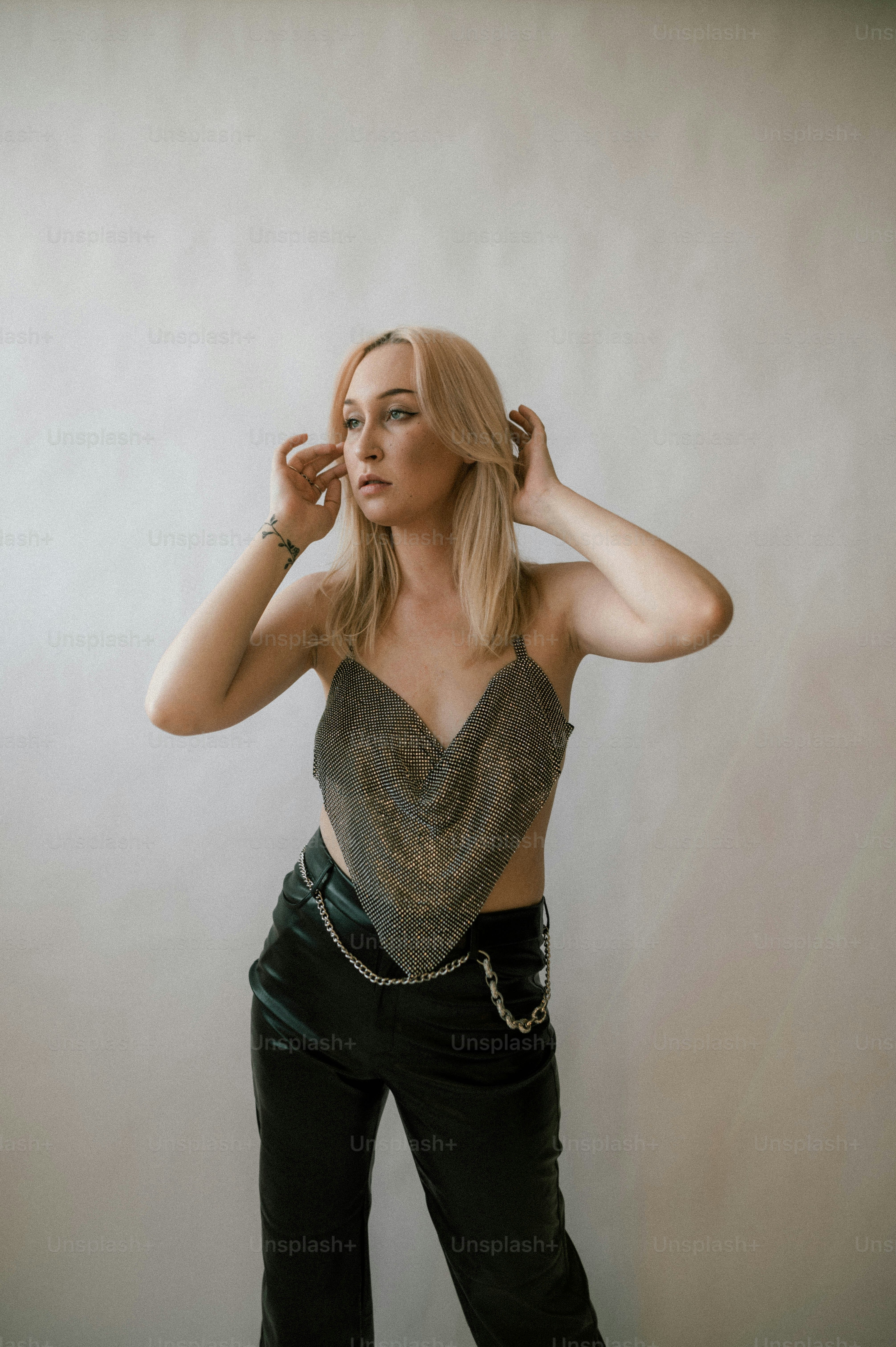 a woman in black pants and a silver top