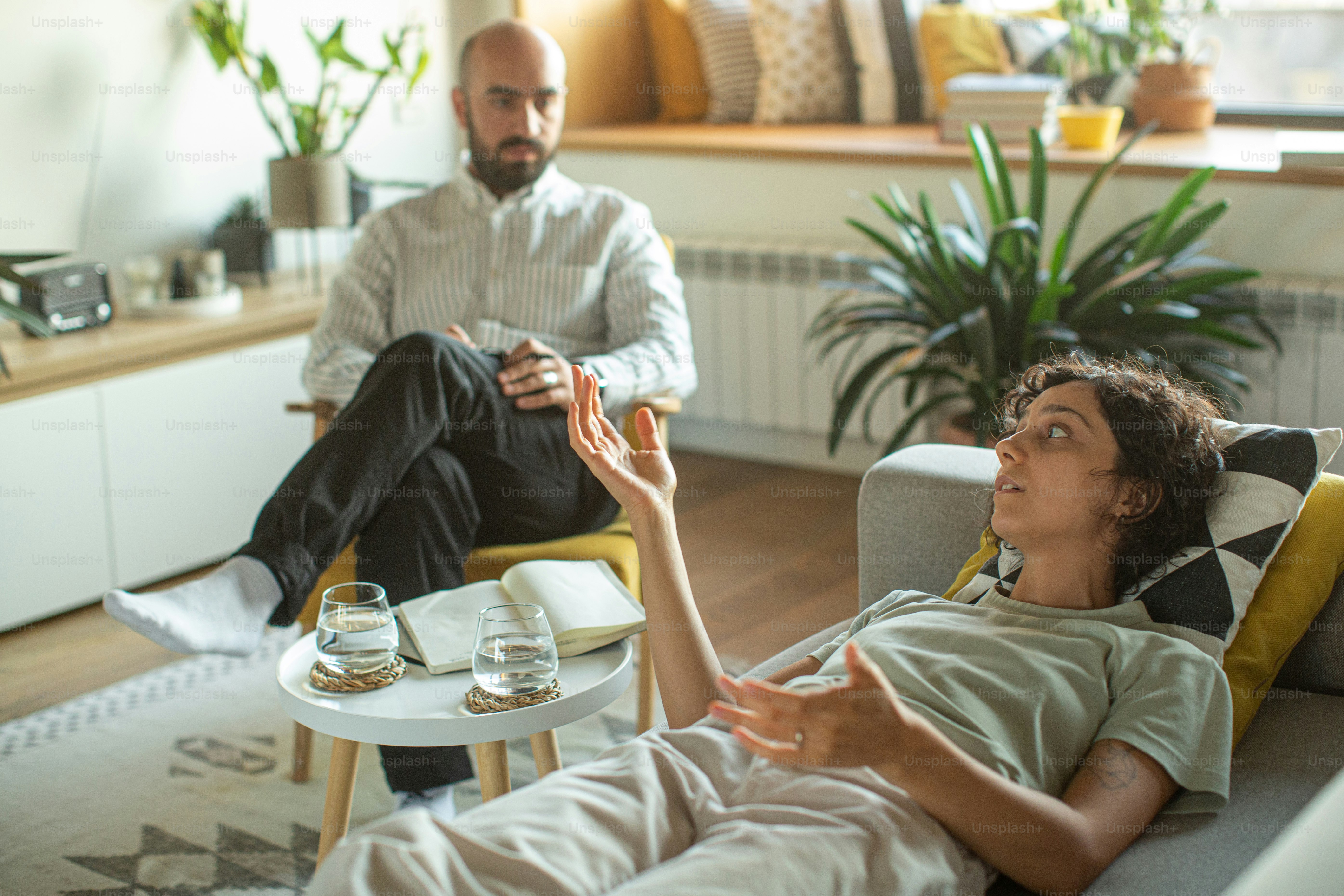 a man sitting on a couch next to a woman
