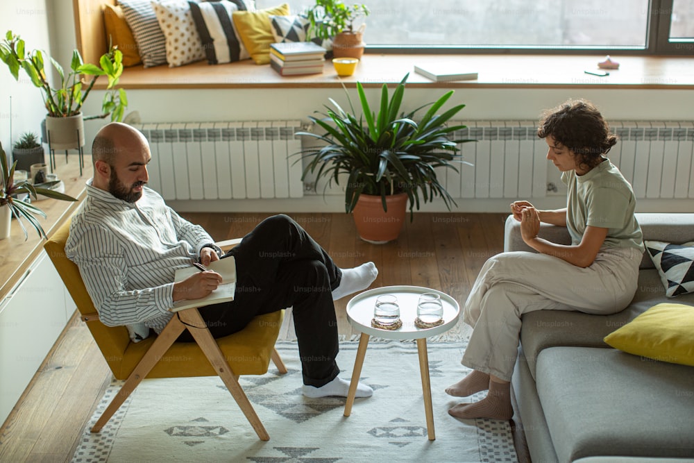a man and a woman sitting on a couch in a living room