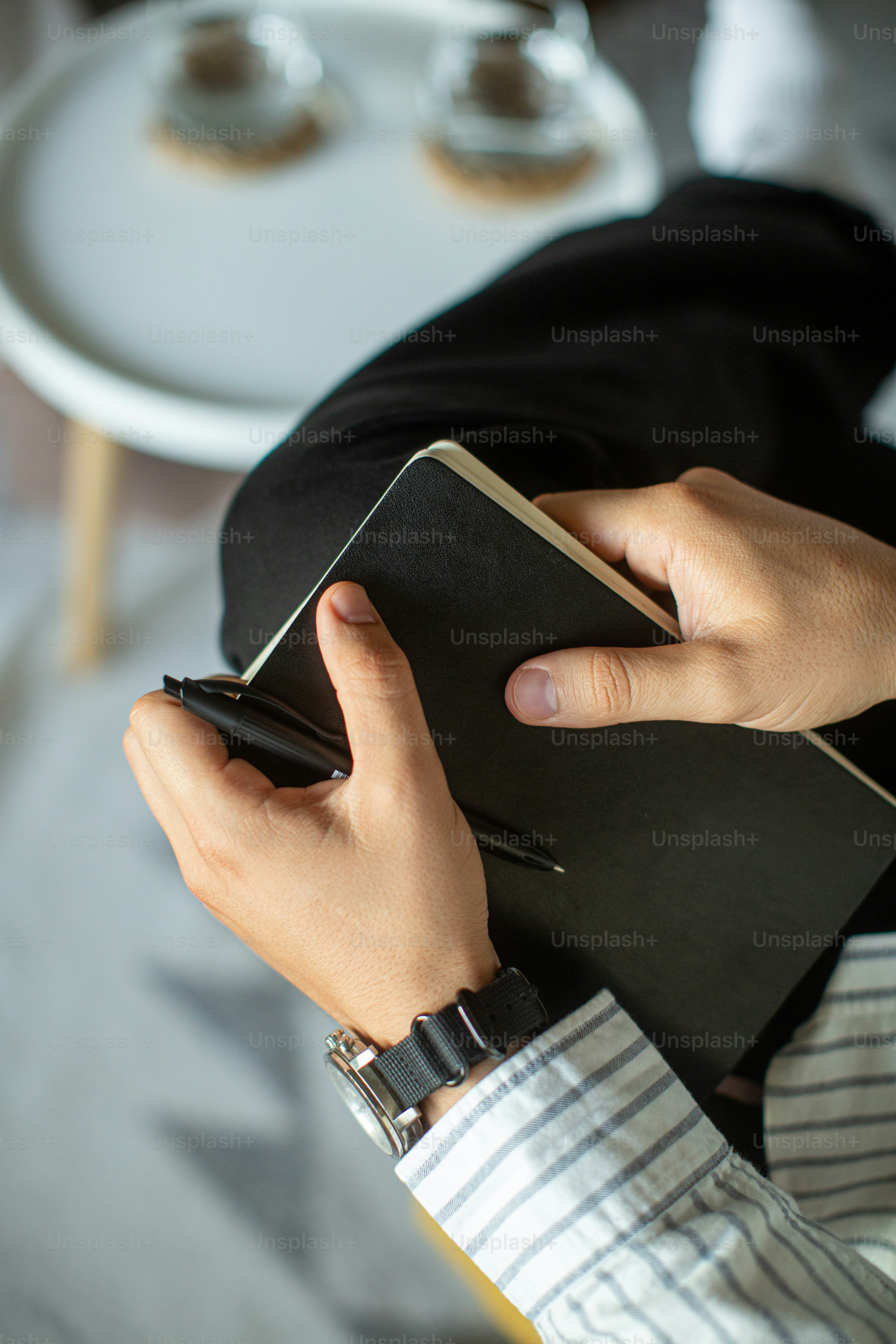a person holding a book and a cell phone