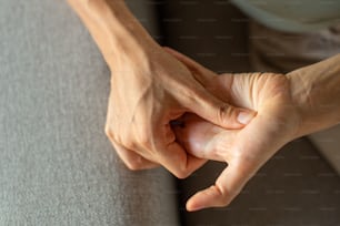 a close up of a person's hands on a couch