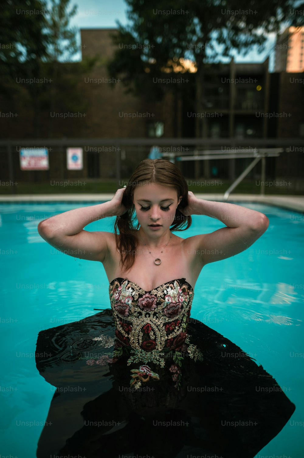 a woman in a bathing suit sitting in a pool