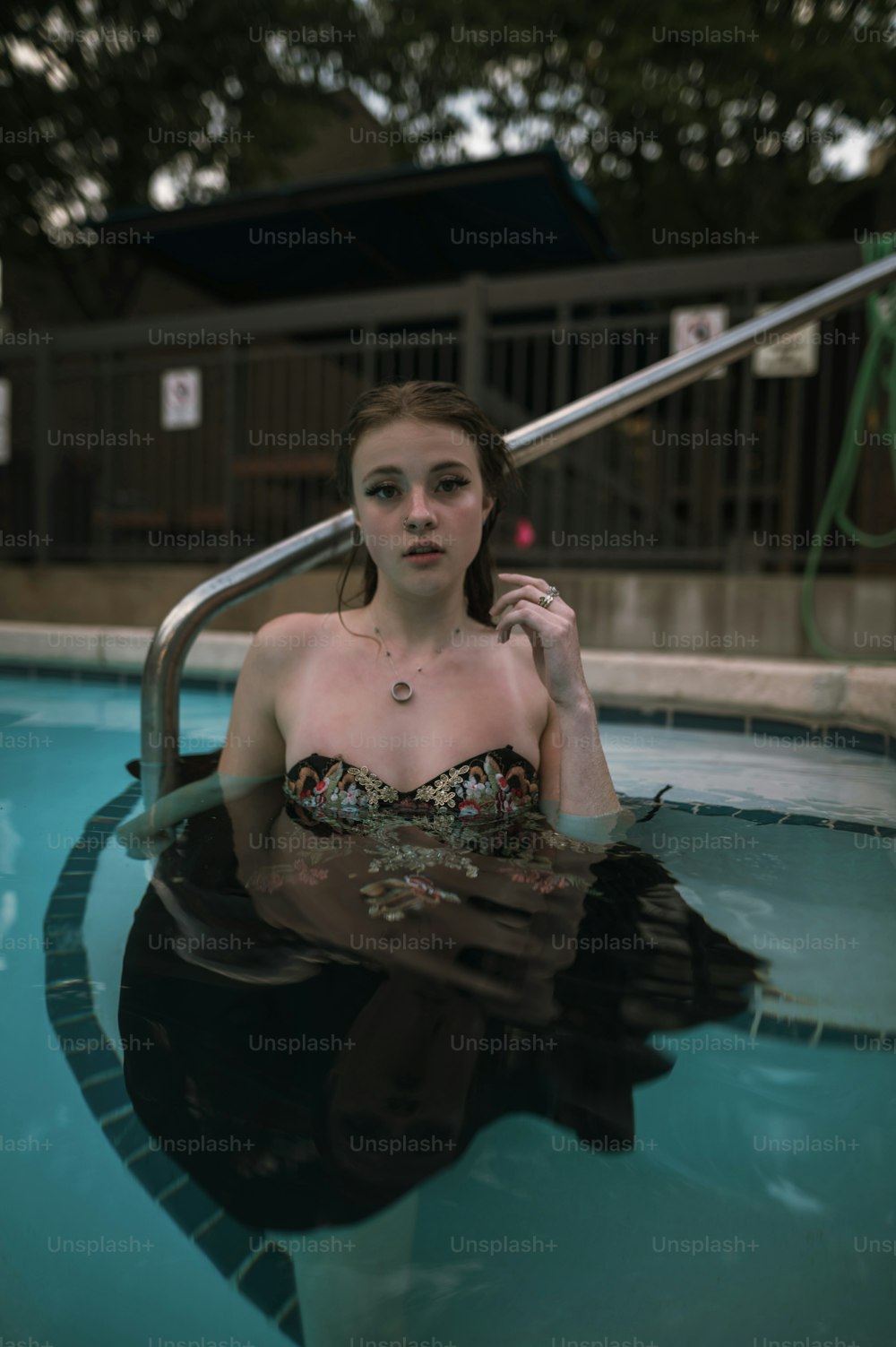 a woman in a bikini sitting in a pool
