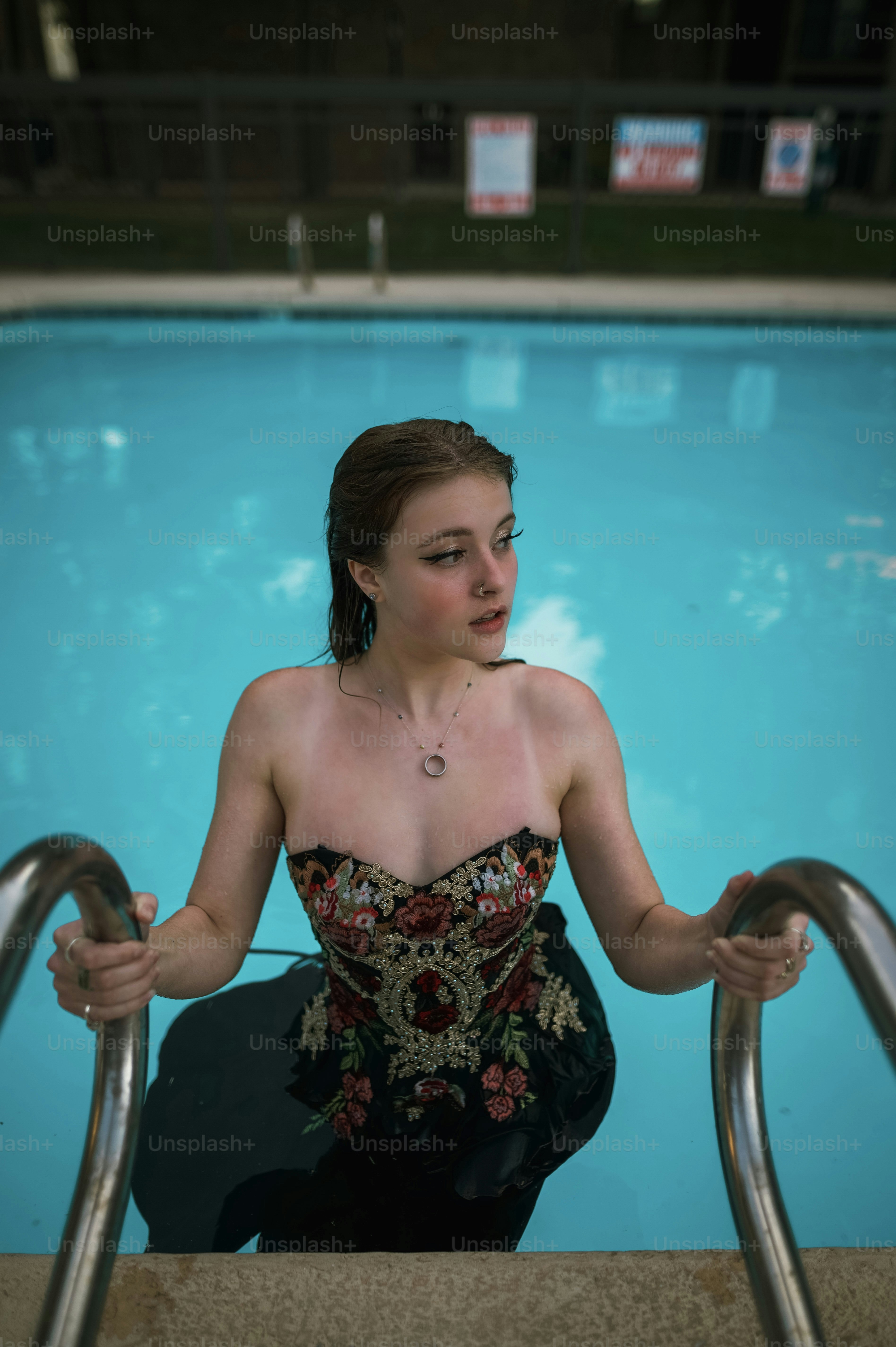 A woman in a bikini standing in a swimming pool photo Selfiestick