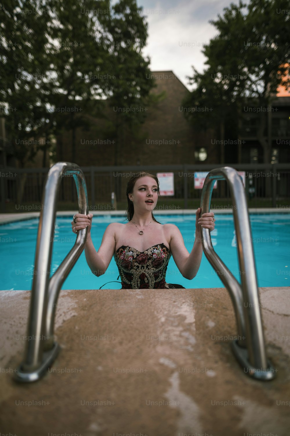 a woman in a bathing suit sitting in a pool