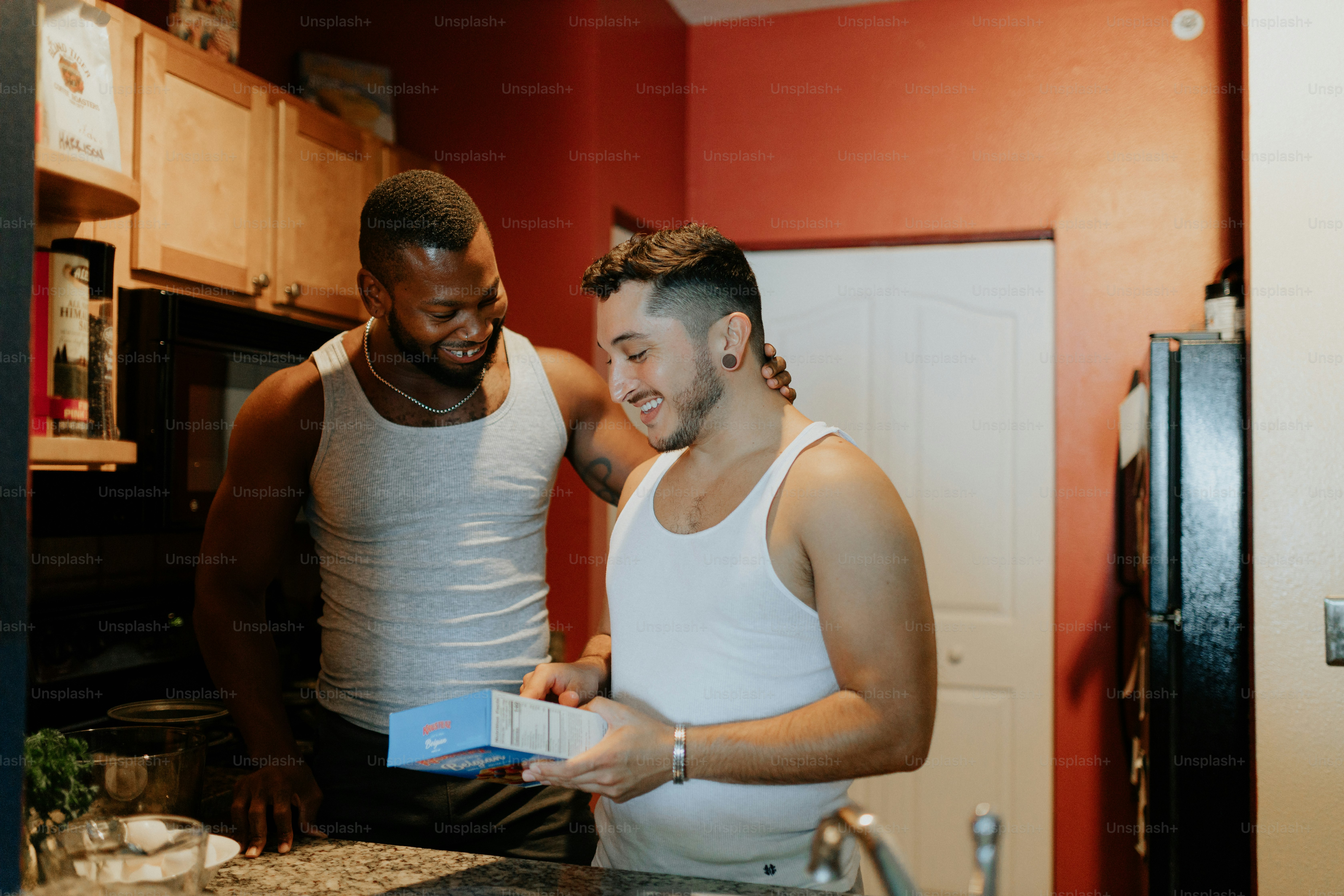 a couple of men standing in a kitchen