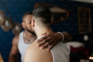 a man is hugging another man in a room