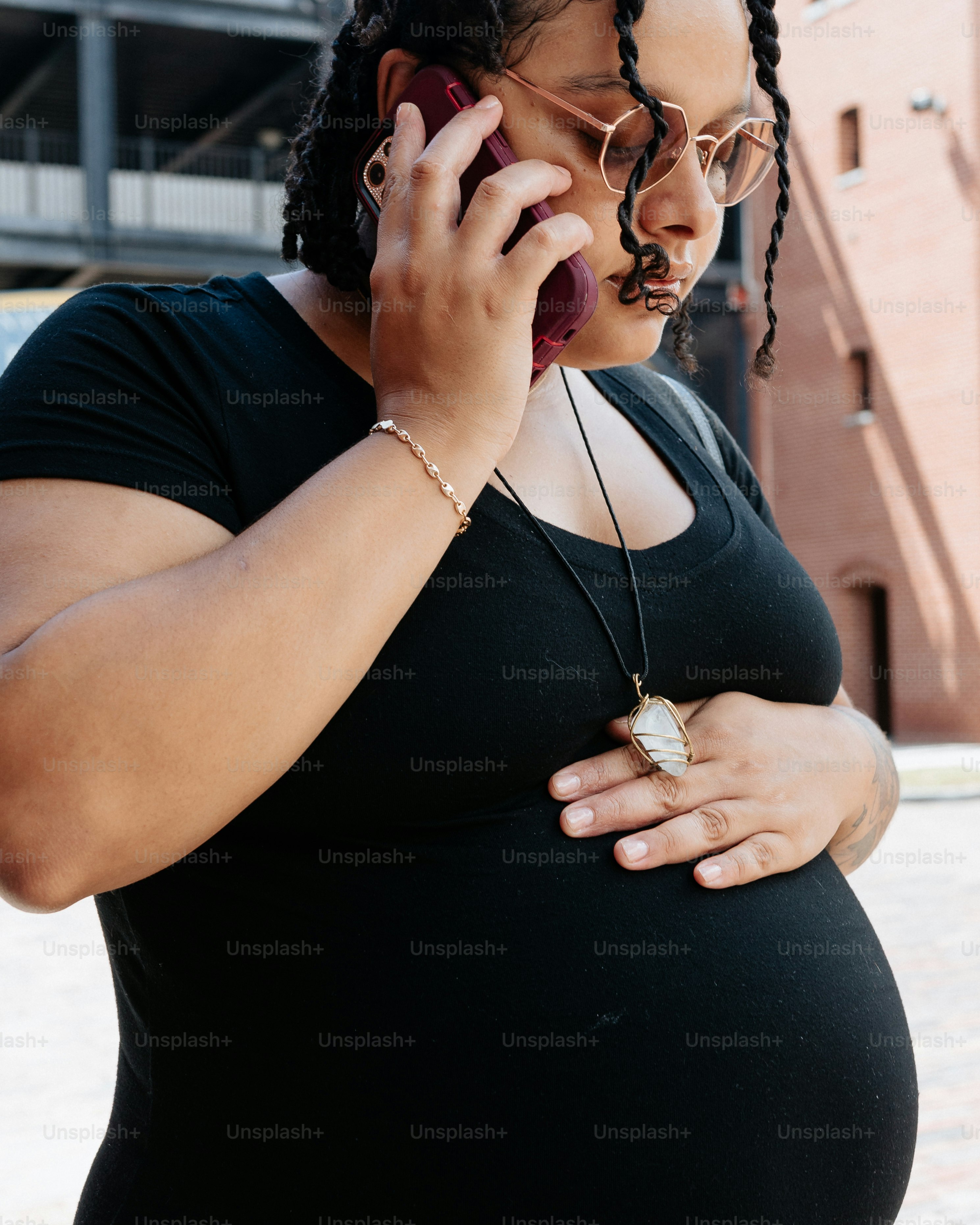 a pregnant woman talking on a cell phone