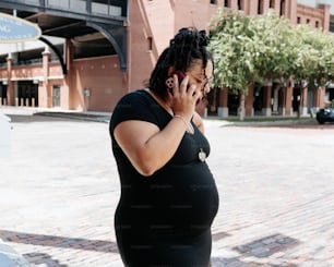a pregnant woman talking on a cell phone
