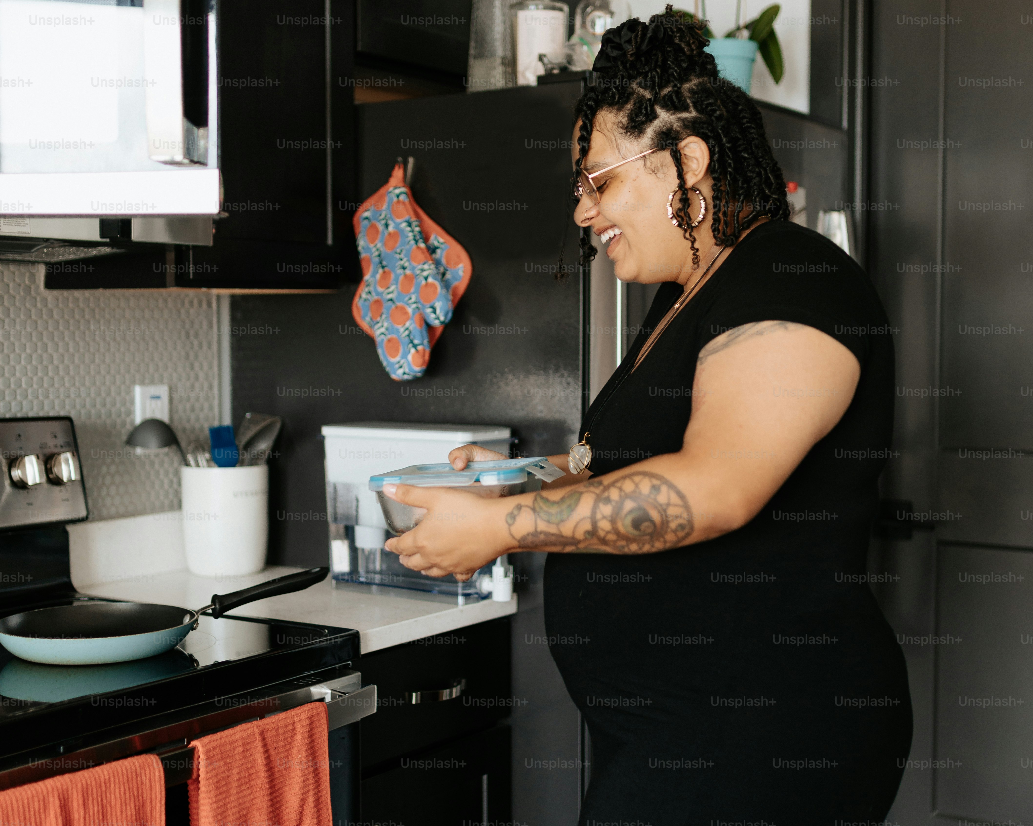 a woman standing in a kitchen preparing food