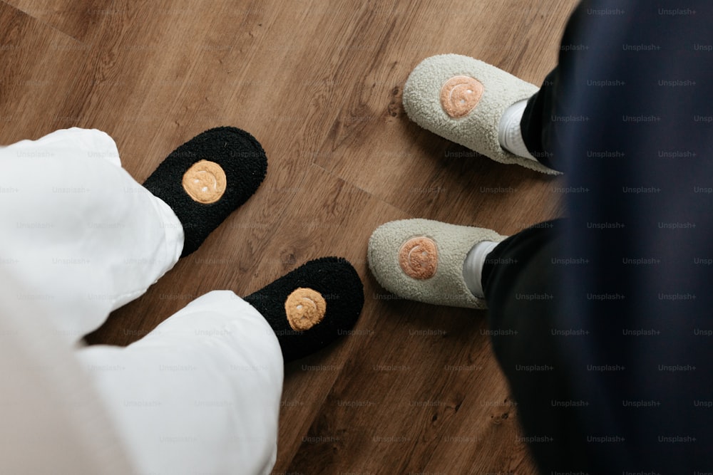 a couple of people standing on top of a wooden floor