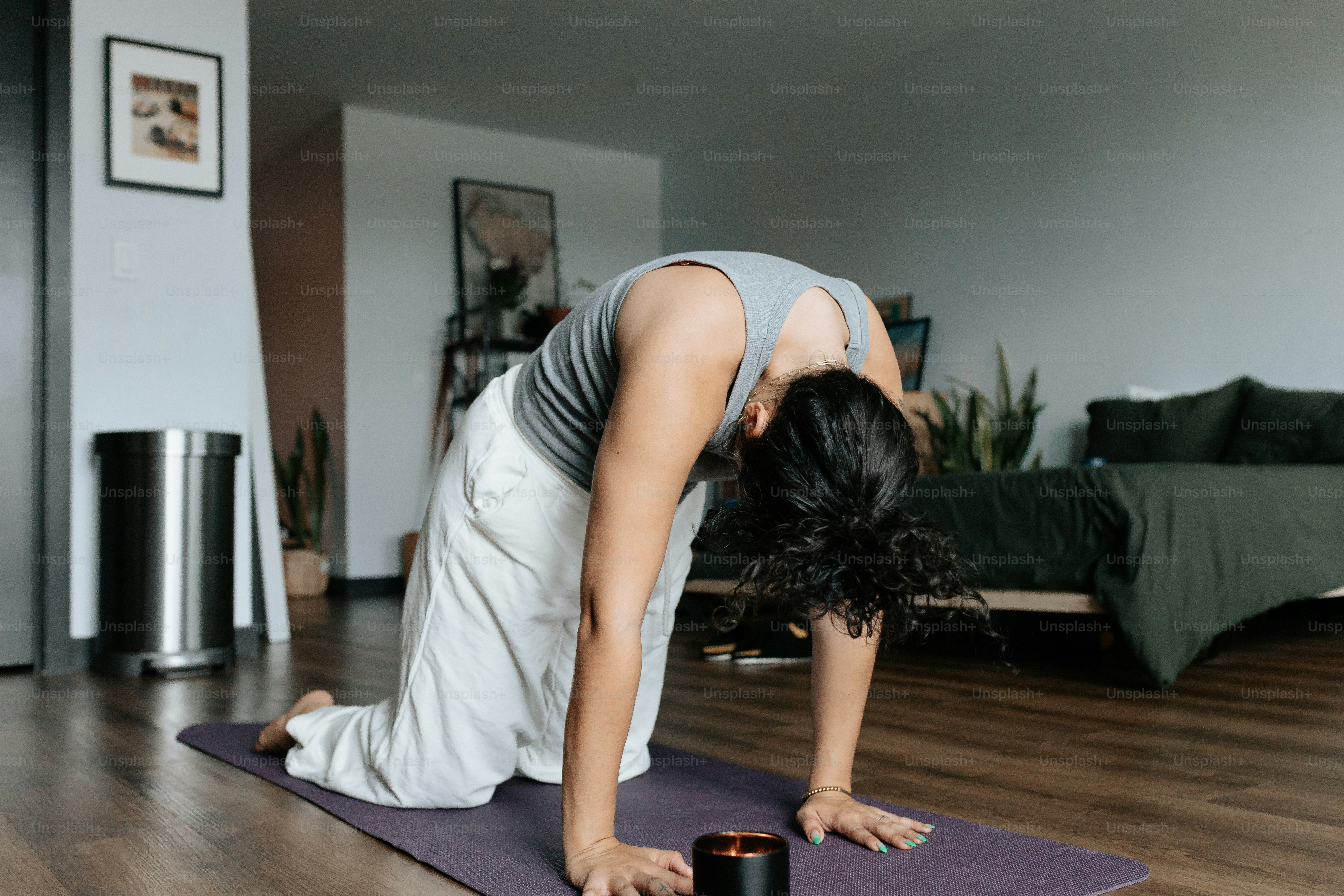 a woman is doing a yoga pose on a mat