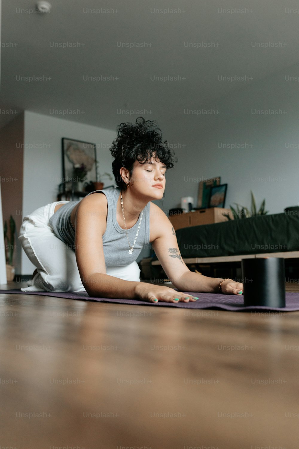 a woman laying on a yoga mat in a living room