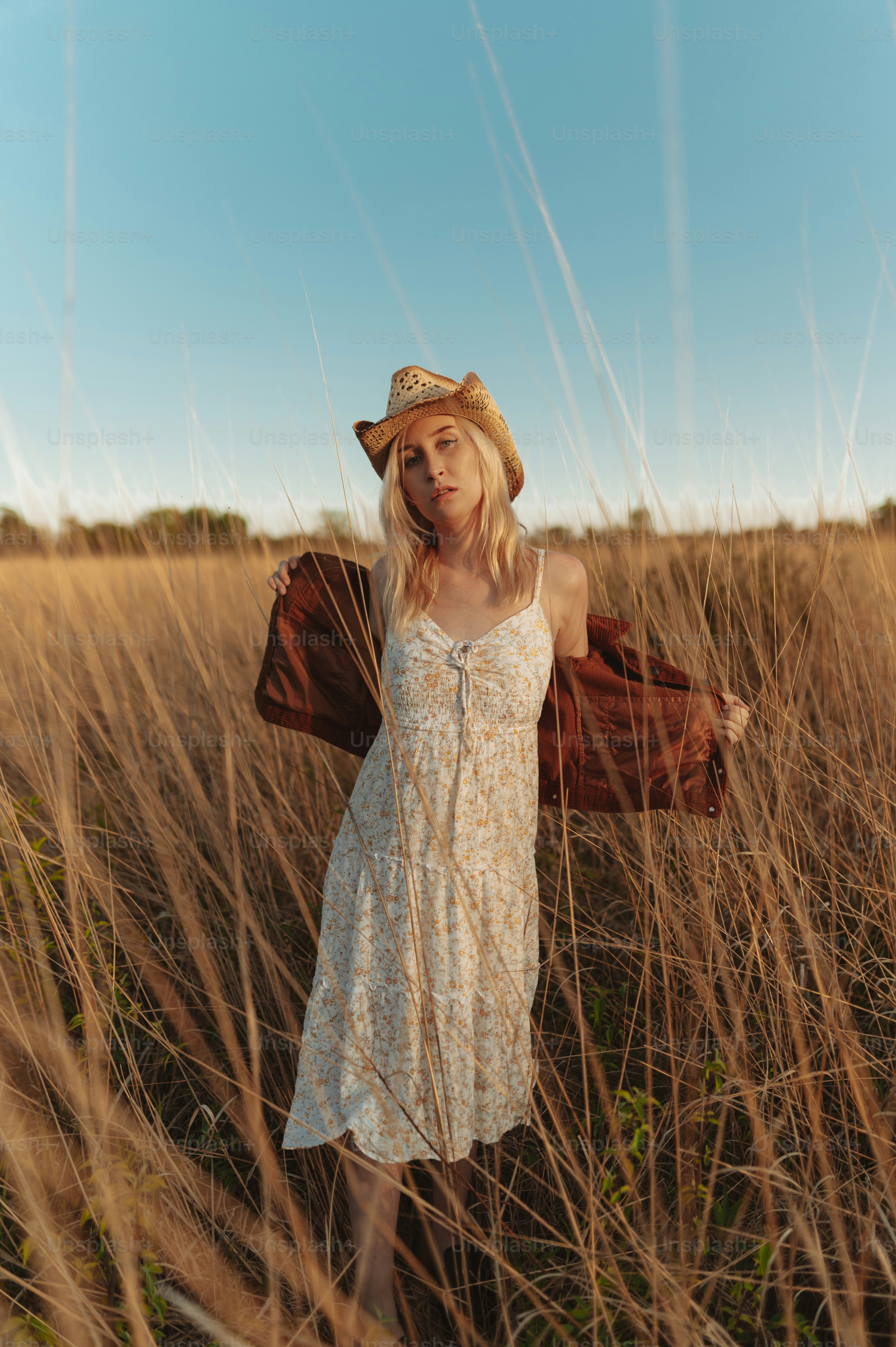 a woman standing in a field of tall grass