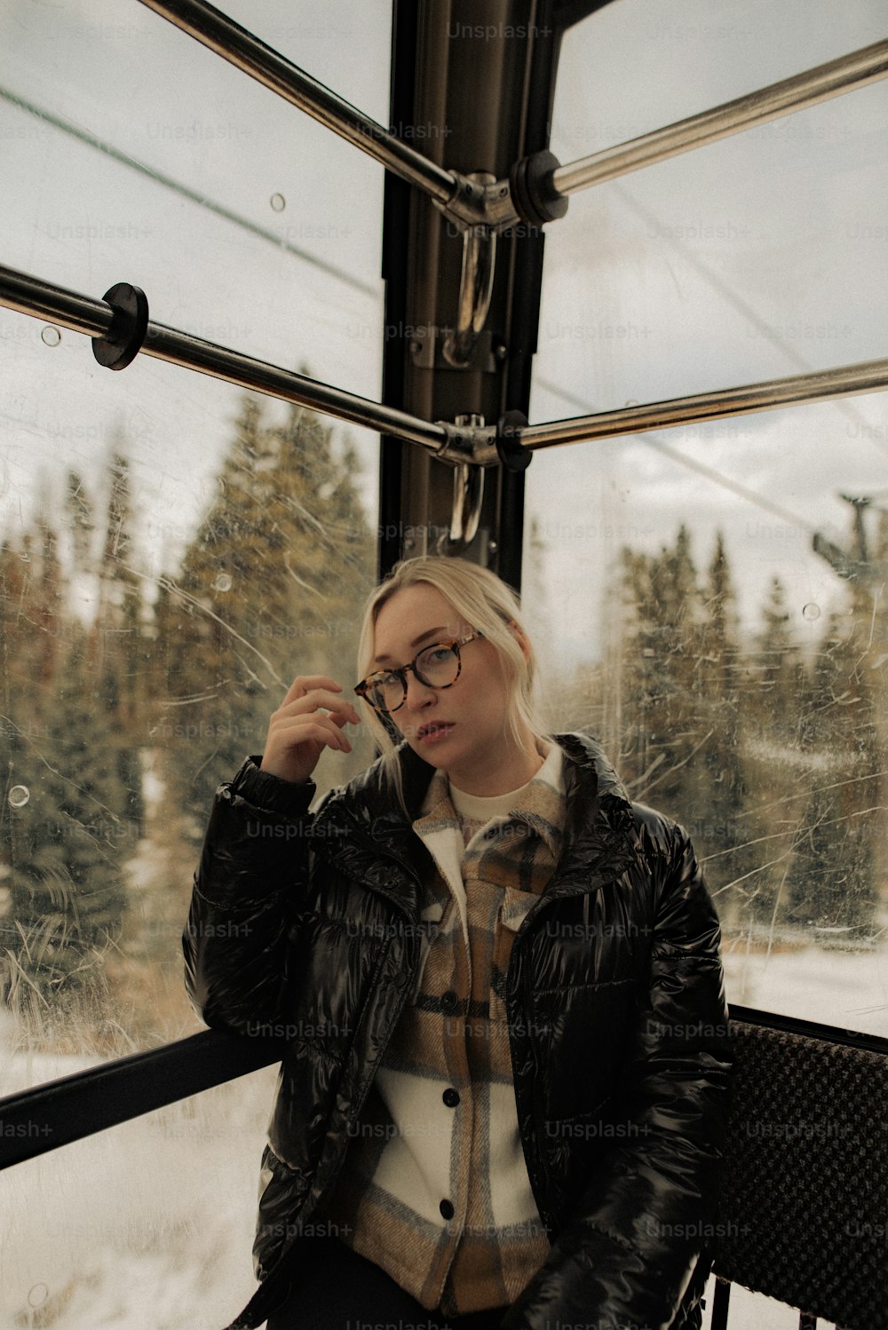 a woman sitting on a bench in front of a window