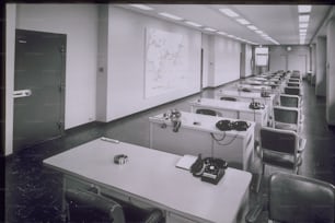 a room filled with lots of desks and chairs