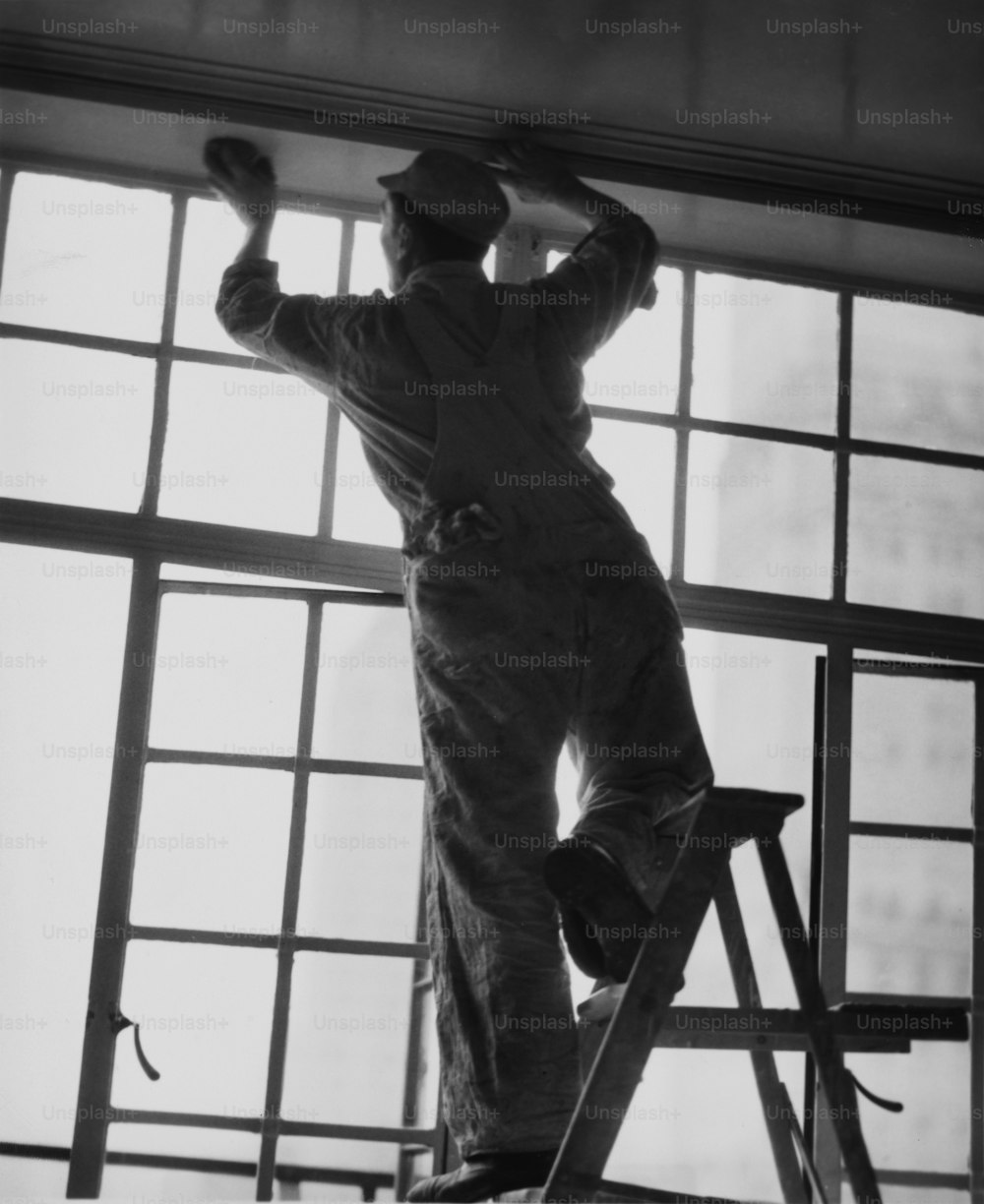A decorator painting a window frame, circa 1950.  (Photo by George Marks/Retrofile/Getty Images)