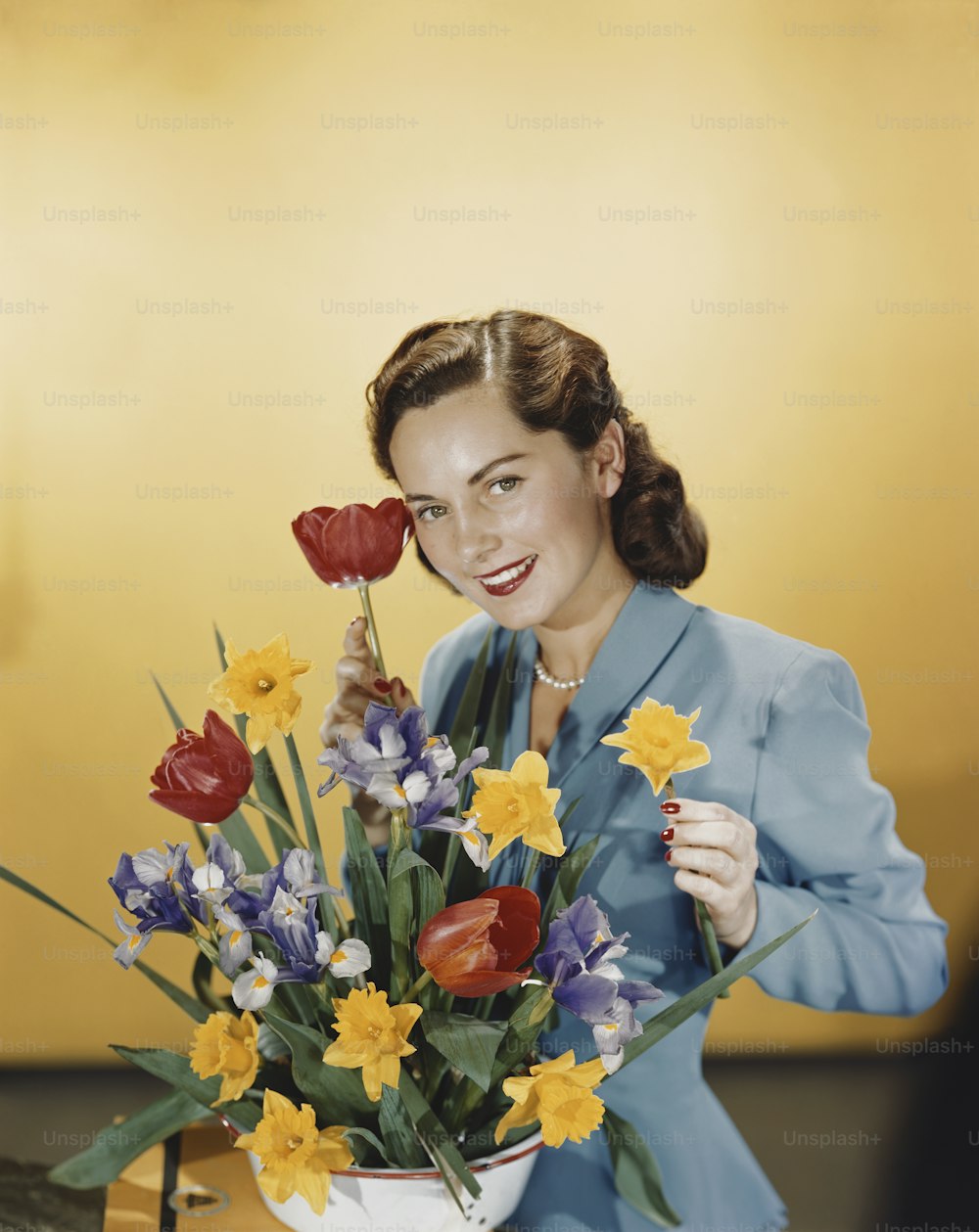 a woman holding a bouquet of flowers in front of her face