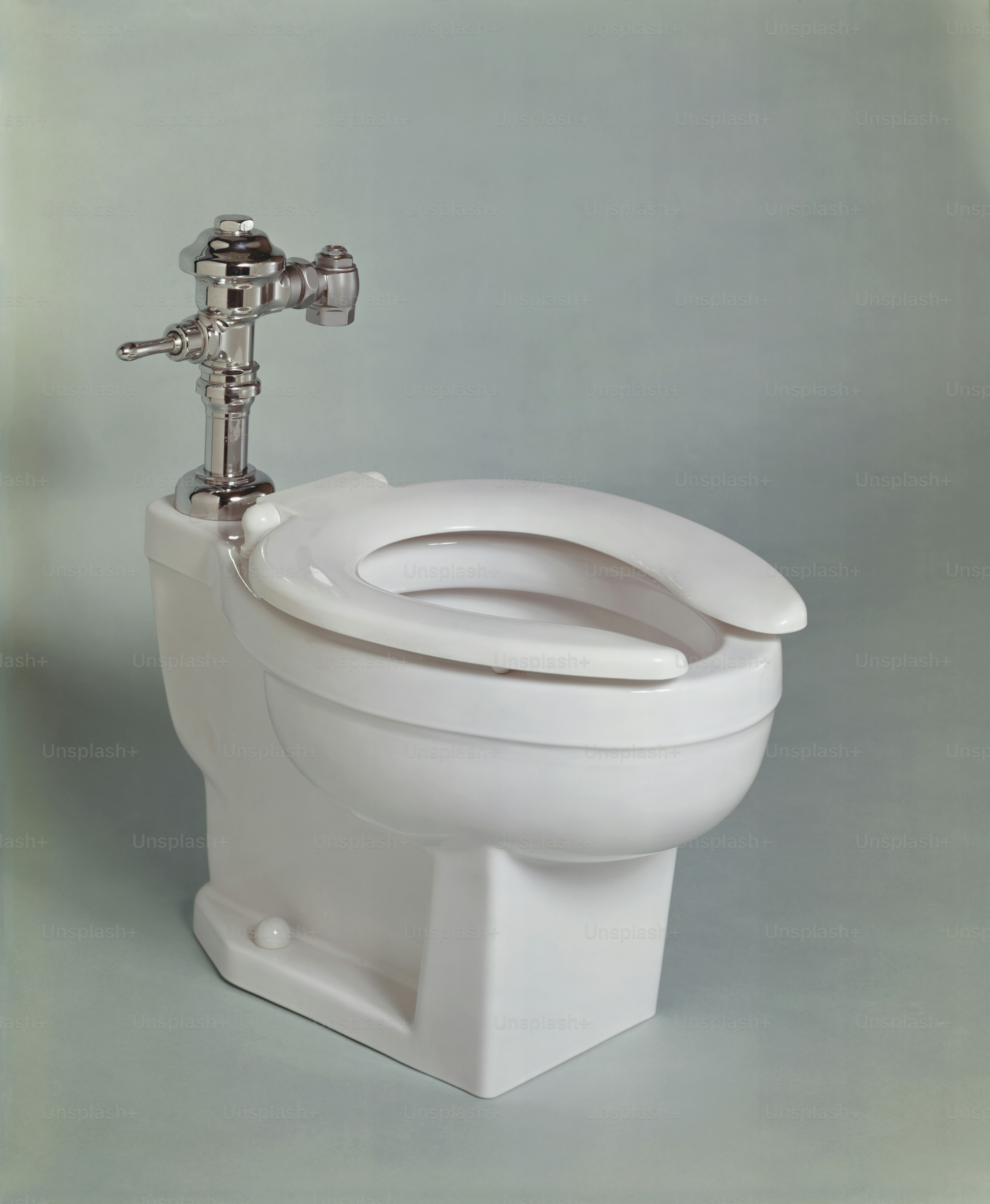 a close up of a toilet with a faucet